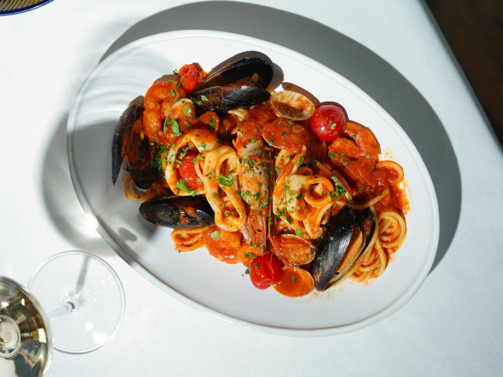 Fresh seafood pasta with tomato sauce and herbs, perfect for gourmet dining.